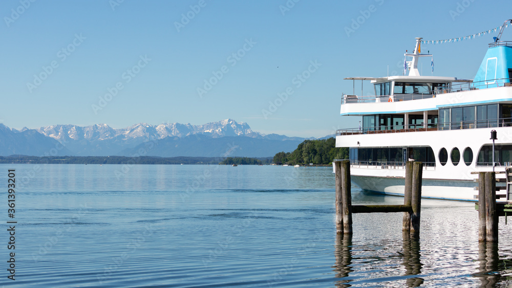 White cruise boat / steamer at Lake Starnberg. Alps with Zugspitze on the horizon. White cruise boat / steamer at Lake Starnberg. Alps with Zugspitze on the horizon.