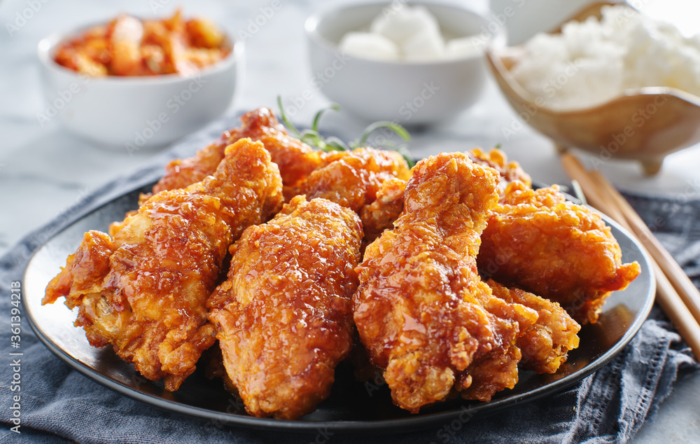 crispy fried korean chicken wings in soy garlic sauce with pickled radish and kimchi sides crispy fried korean chicken wings in soy garlic sauce with pickled radish and kimchi sides