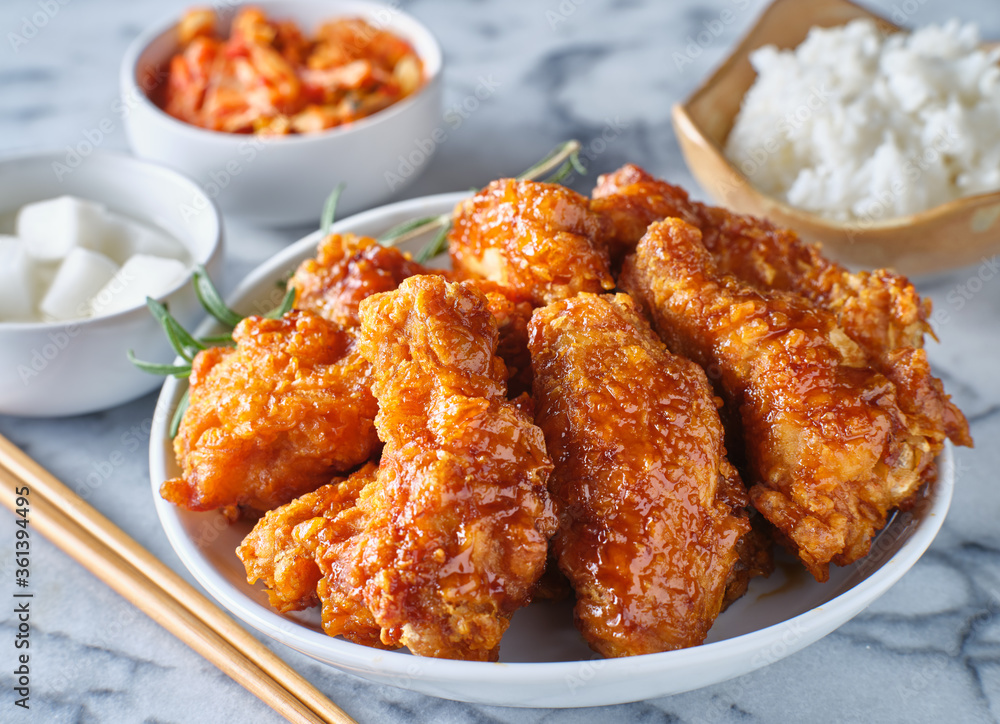 crispy fried korean chicken wings in soy garlic sauce with pickled radish and kimchi sides crispy fried korean chicken wings in soy garlic sauce with pickled radish and kimchi sides