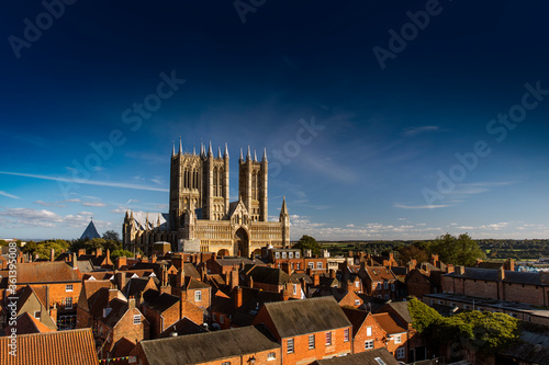 Fotografiet West Front of Lincoln Cathedral over rooftops with lots of sky room, Lincoln, Li