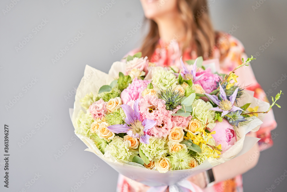 Beautiful bouquet of mixed flowers in woman hand. Floral shop concept . Handsome fresh bouquet. Flowers delivery. Beautiful bouquet of mixed flowers in woman hand. Floral shop concept . Handsome fresh bouquet. Flowers delivery.