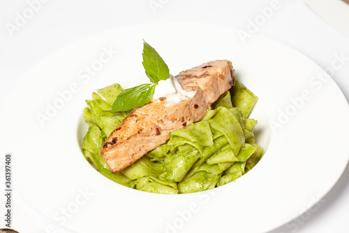 Salmon steak with pasta and fresh basil