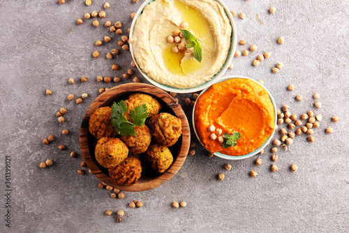 Traditional homemade hummus, falafel and chickpea on rustic table. Jewish Cuisine. photo