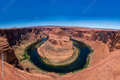 Horeshoe Bend Canyon Arizona tourist destination landscape view public landmark river erosion with blue sky and hazy clouds  photo