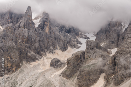 Pale di San Martino southern mountain chain of the Dolomites with Cimon della Palla & Cima Vezzana mountain peaks on a partly cloudy, misty day as seen from Baita Segantini refuge, Passo Role,Italy. photo