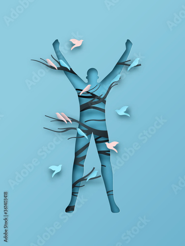 Papercut man in success pose with trees and birds