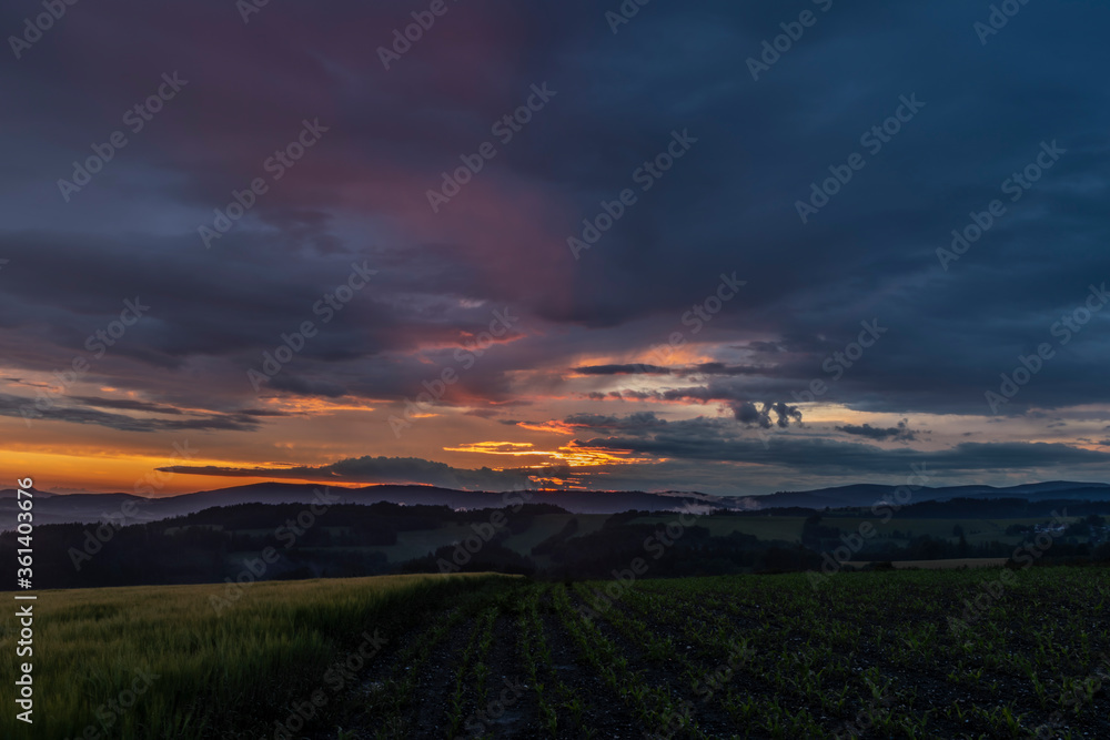 Obraz premium Sunset in hot summer rainy evening near Roprachtice village
