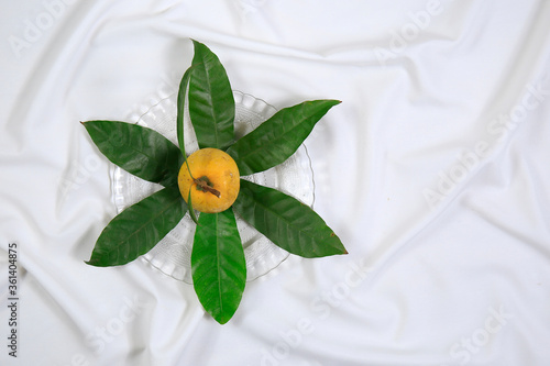 Wallpaper Mural Fresh tasty eggfruit decorated with leaves on a glass bowl Torontodigital.ca