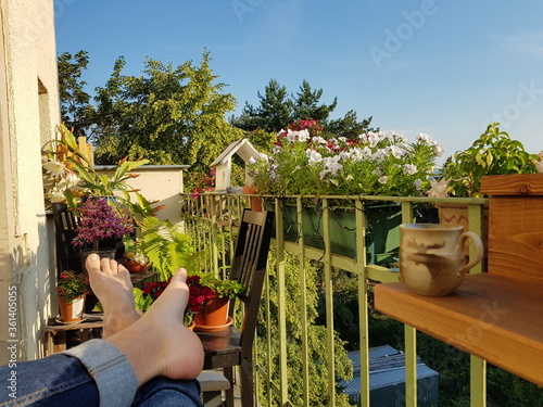 Fotobehang Relaxing on a blooming balcony in summer