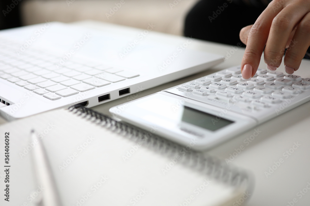 Woman hand considers on calculator close up. Woman hand considers on calculator close up.