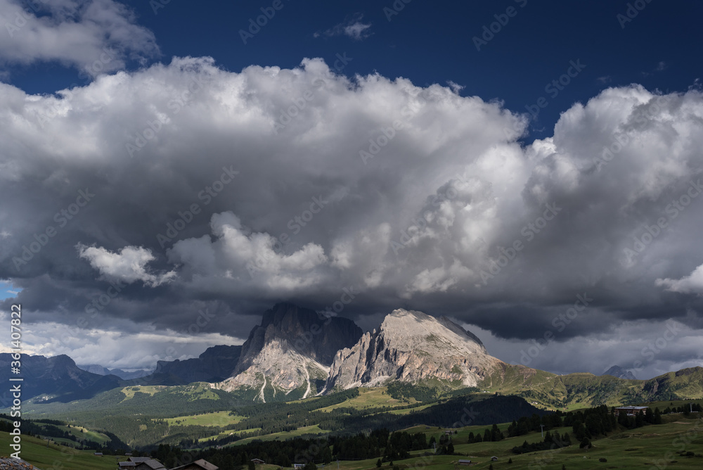 Dramatic cloud formations above Sassolungo & Sassopiatto mountain groups with Sella mountain group behind as seen from Alpe di Siusi/Seiser Alm high alpine plateau, Dolomites, South Tirol, Italy.