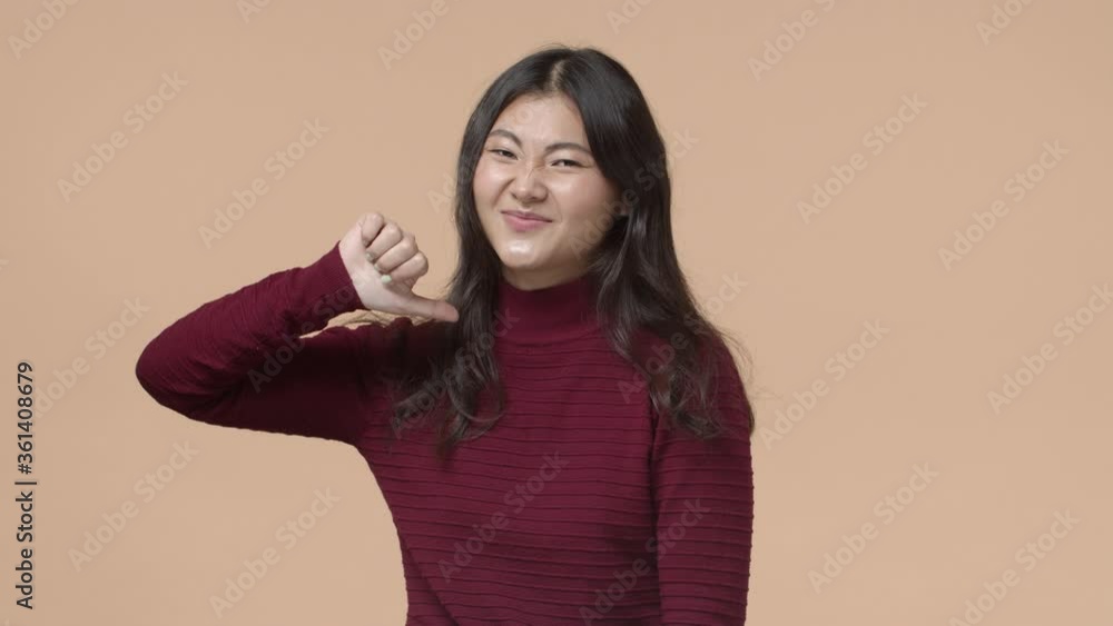 So bad and lame. Unsatisfied and disappointed attractive asian girl, shaking head and grimacing displeased, show thumb-down in disagree, dislike product or event, have awful experience So bad and lame. Unsatisfied and disappointed attractive asian girl, shaking head and grimacing displeased, show thumb-down in disagree, dislike product or event, have awful experience