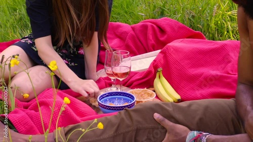 Couple having romantic picnic with wine in a park - 8 sec photo