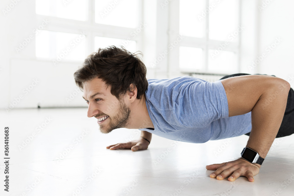 Man doing push-ups during calisthenic workout in the gym Man doing push-ups during calisthenic workout in the gym
