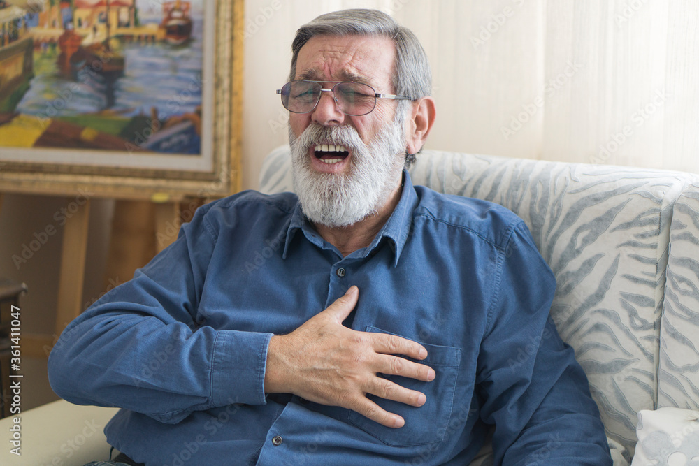 Senior man having a heart attack. 