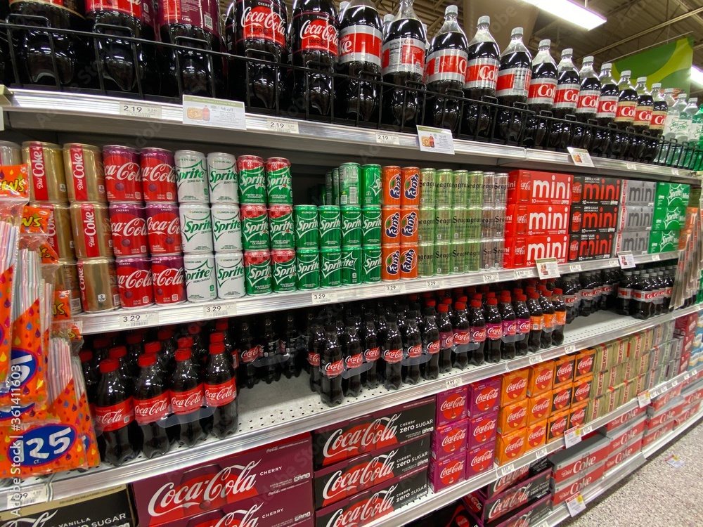 TRINITY, FLORIDA - June 27,2020: Coca-Cola (NYSE: KO) dominates shelf space at supermarket. The Coca-Cola Company is an American multinational beverage corporation headquartered in Atlanta, Georgia. Stock Photo | Adobe Stock