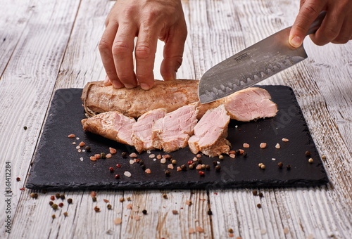 Smoked meat, cutting meat on a cutting board