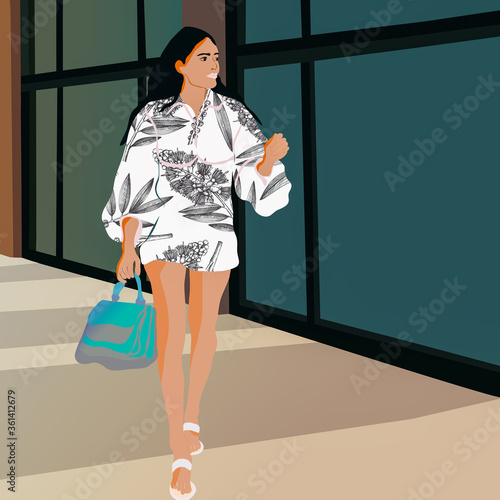 Postać młodej modnie ubranej dziewczyny przechadzającej się po ulicy