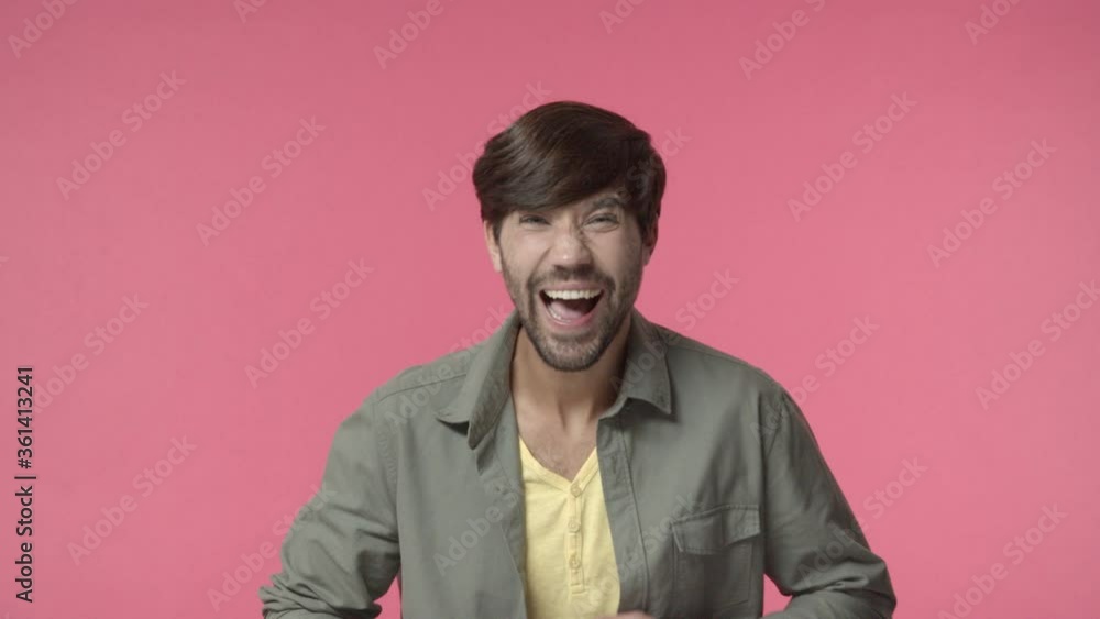 Handsome bearded adult man look camera starts laughing over hilarious tv series, joking, chuckle and clap hands as watching stand-up comedy performance, standing pink background Handsome bearded adult man look camera starts laughing over hilarious tv series, joking, chuckle and clap hands as watching stand-up comedy performance, standing pink background