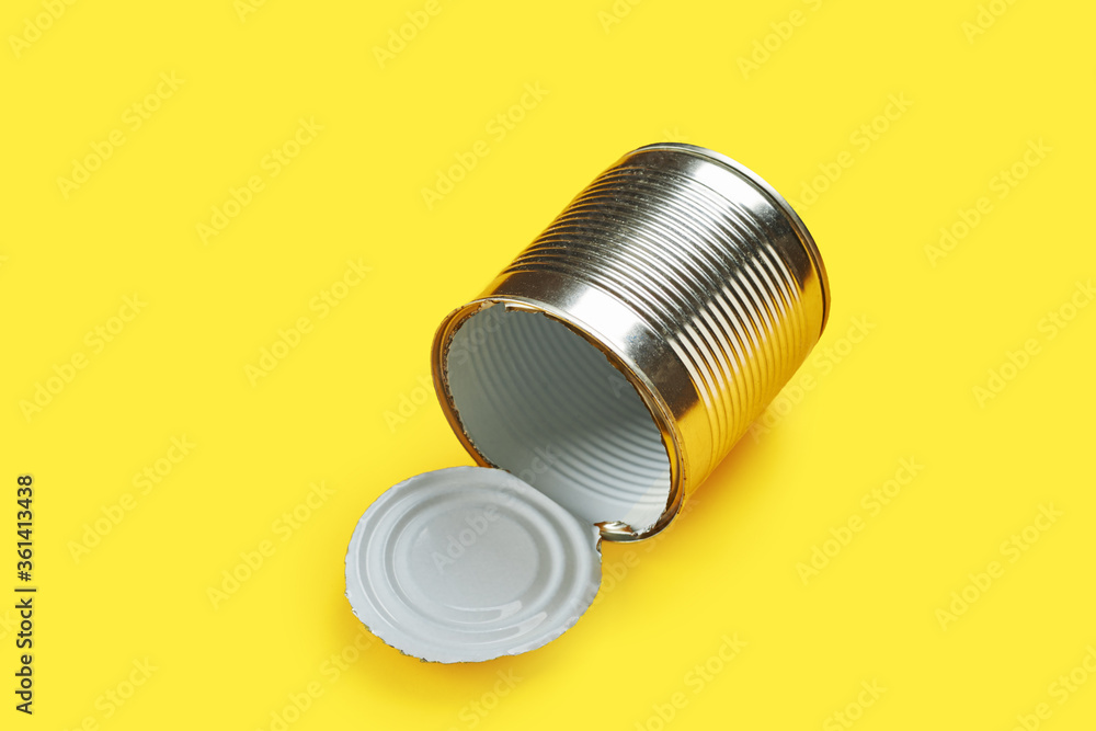 empty metal tin can isolated over yellow background. environment conversation concept. recycling concept. empty metal tin can isolated over yellow background. environment conversation concept. recycling concept.