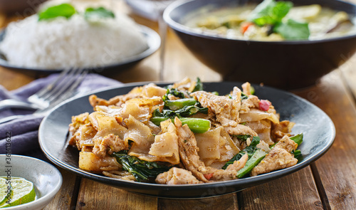 thai pad see ew with pork and chinese borccoli on plate