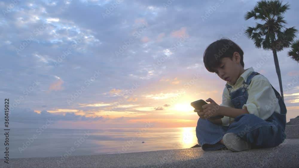 A boy have fun at Promtep cape..Promthep cape is the most popular viewpoint in Phuket island. the most tourist always come to see sunset at this landmark.