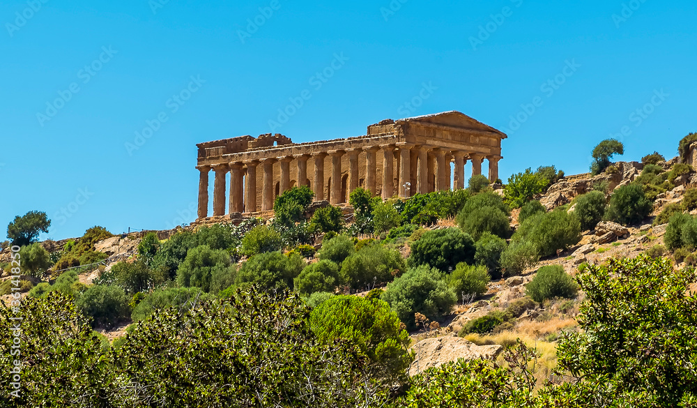The Temple of Concordia viewed from the base of the ridge in the ancient Sicilian city of Agrigento in summer