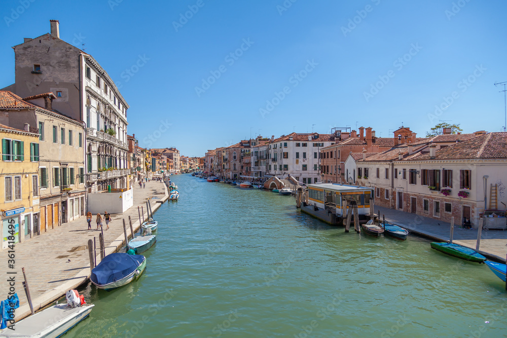 Classical picture of the venetian canals with gondola.
