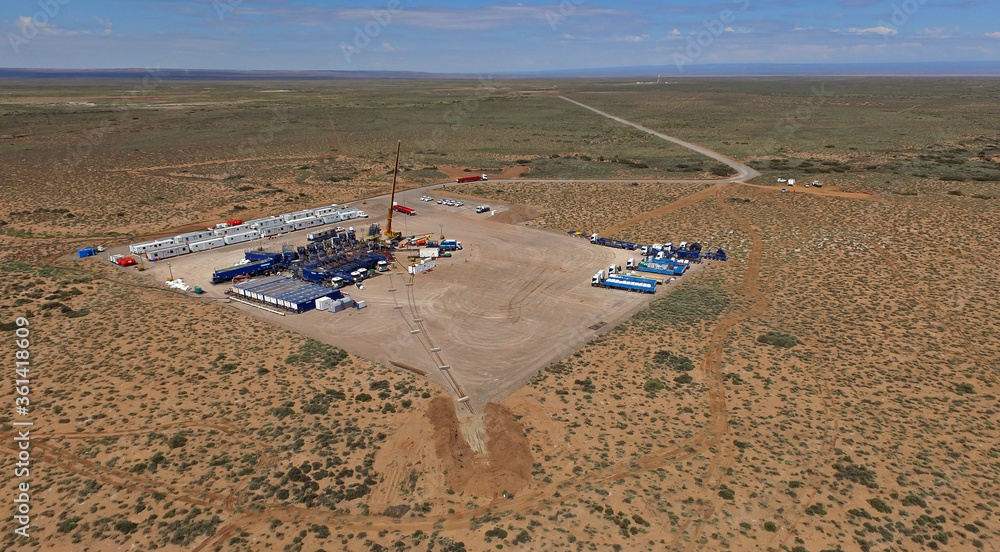 Vaca Muerta, Argentina, December 25, 2015: Extraction of unconventional oil. Battery of pumping trucks for hydraulic fracturing (Fracking). Vaca Muerta, Argentina, December 25, 2015: Extraction of unconventional oil. Battery of pumping trucks for hydraulic fracturing (Fracking).