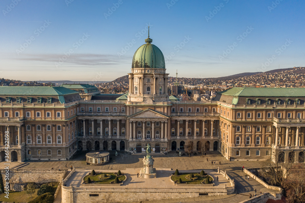 Aerial drone shot of front facade of Buda castle palace complex during Budapest morning sunrise
