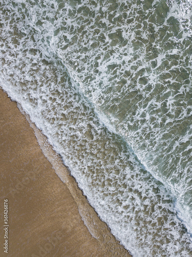 Aerial photo of waves breaking near a rural surf beach, New Zealand. 