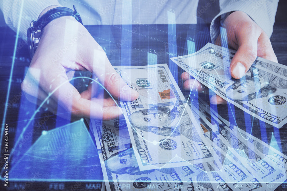 Multi exposure of financial graph drawing hologram and USA dollars bills and man hands. Analysis concept. Multi exposure of financial graph drawing hologram and USA dollars bills and man hands. Analysis concept.