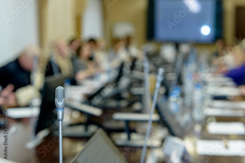 Business people work discussion concept, microphone in the foreground.