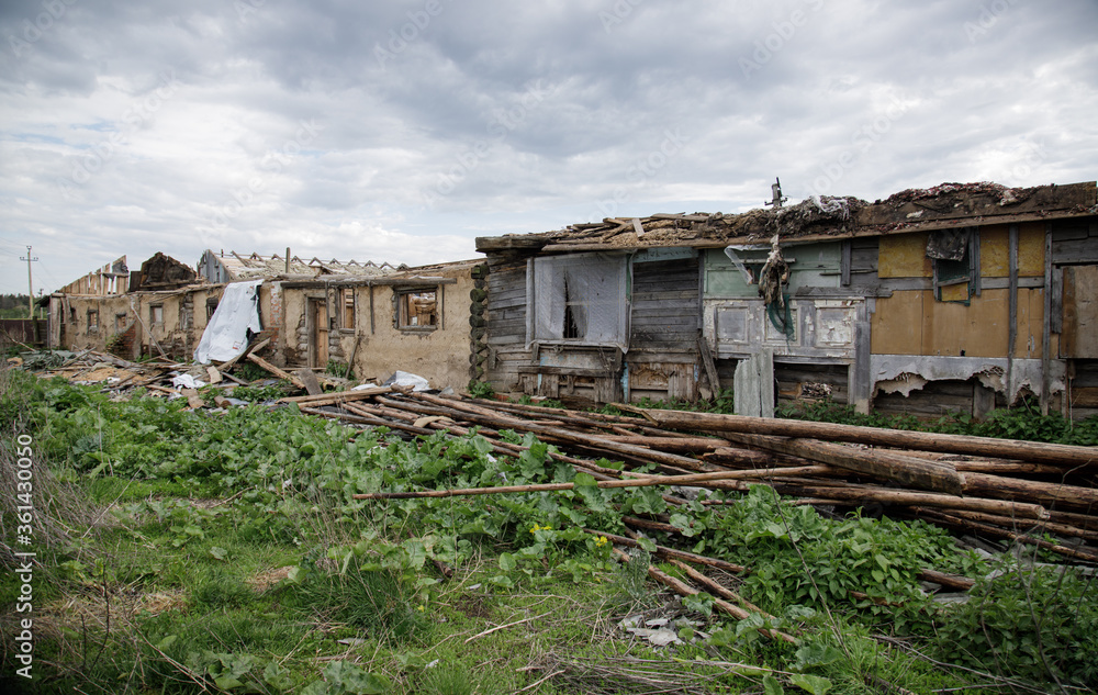 Abandoned ruins of a wooden house, farm. Old industrial building.