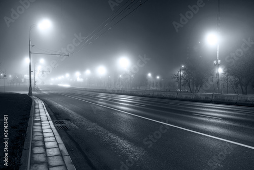 night road in fog, long exposure, black and white, dark image © kurtov