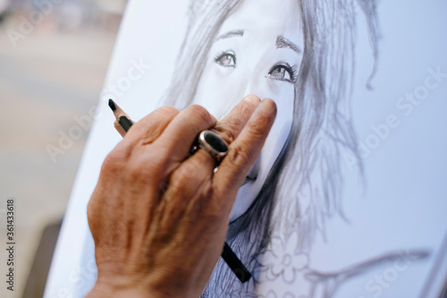 Slika na platnu Street Painter Drawing Portrait Of Tourist With Charcoal