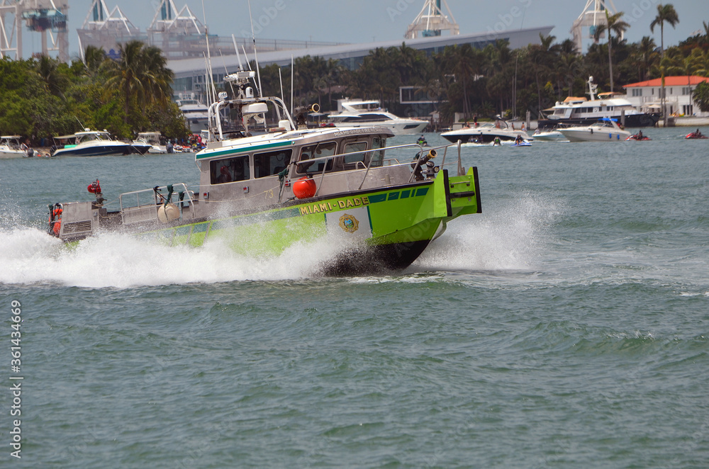 Fototapeta premium Miami-Dade fire rescue boat speeding across the Florida Intra-Coastal Waterway off of Miami Beach.