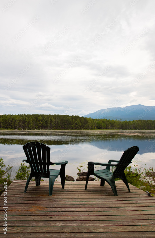 Green Lawn Chairs Overlooking a Mountain Lake in Maine