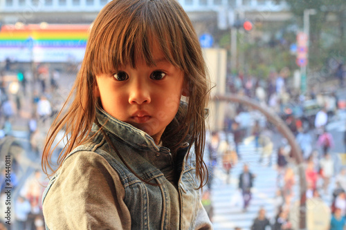Wallpaper Mural A young girl with Shibuya Crossing in Tokyo, Japan in the background. Torontodigital.ca