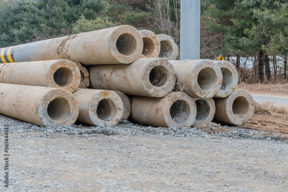Concrete utility poles at construction site Concrete utility poles at construction site