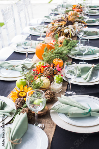Formal Thanksgiving table and chavari chairs in the fall family group for holiday dinner