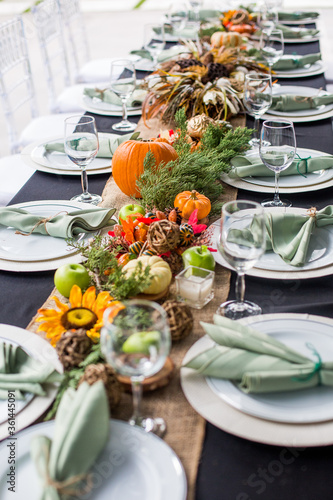 Formal Thanksgiving table and chavari chairs in the fall family group for holiday dinner