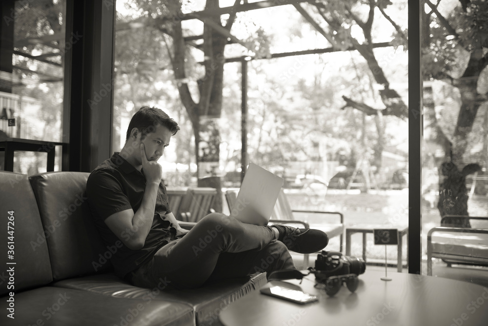 Portrait of a young freelance man sitting at a coffee shop desk Portrait of a young freelance man sitting at a coffee shop desk