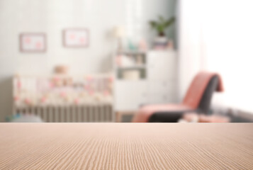 Empty wooden table in baby room interior