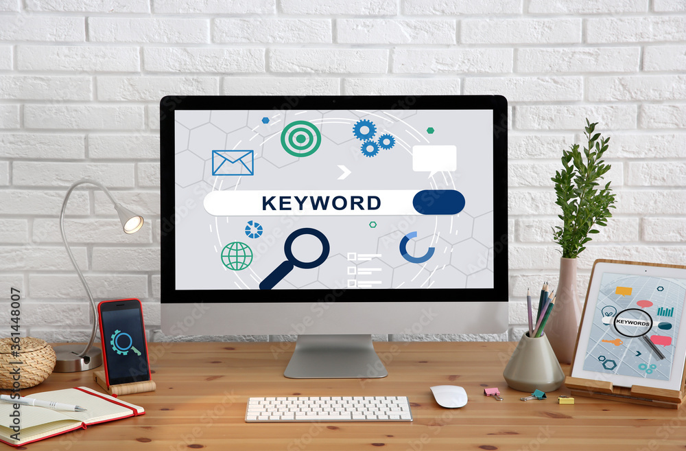 Keywords research concept. Modern computer with search bar on wooden table Keywords research concept. Modern computer with search bar on wooden table