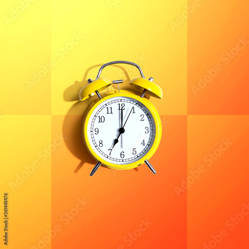 Yellow vintage alarm clock with shadow - flat lay