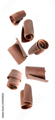 Fotografie Set with yummy chocolate curls falling on white background