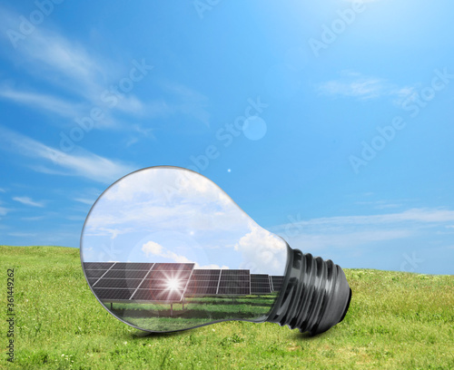 Alternative energy source. Light bulb with solar panels outdoors