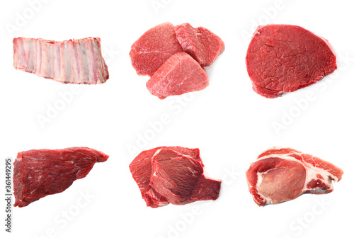 Set with raw meat on white background, top view