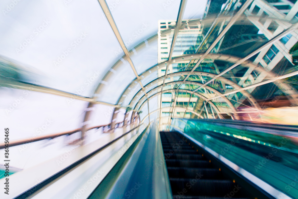 Fototapeta premium Abstract motion blurred view through an escalator tunnel